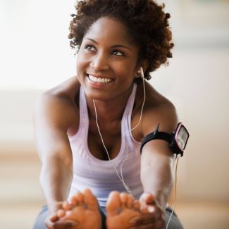 Woman exercising with earbuds representing employee wellness and work-life balance benefits