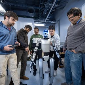 Students working together with a robot in a lab setting
