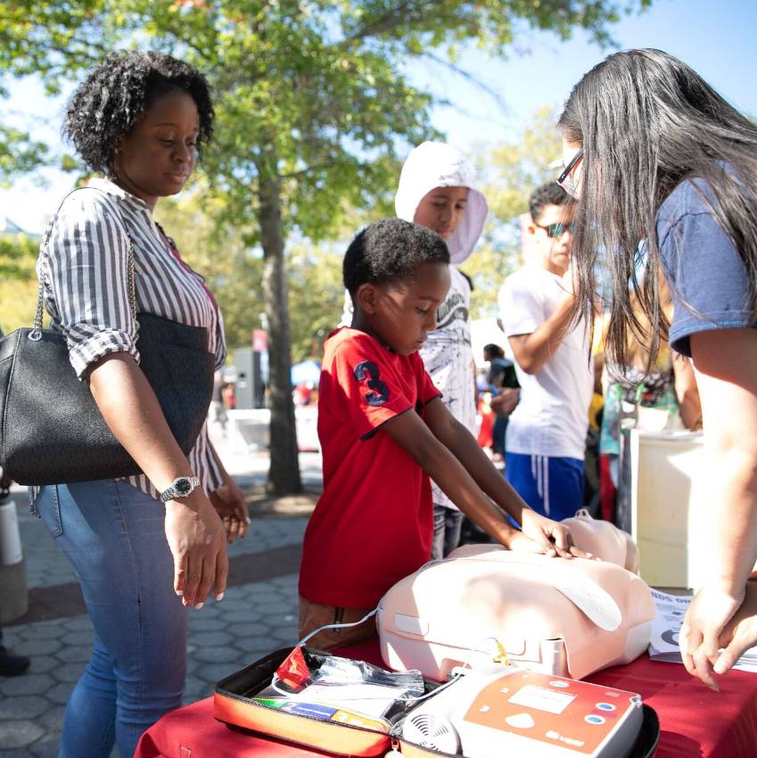 Young child learning about the heart at the Stony Brook University CommUniversity Day event.