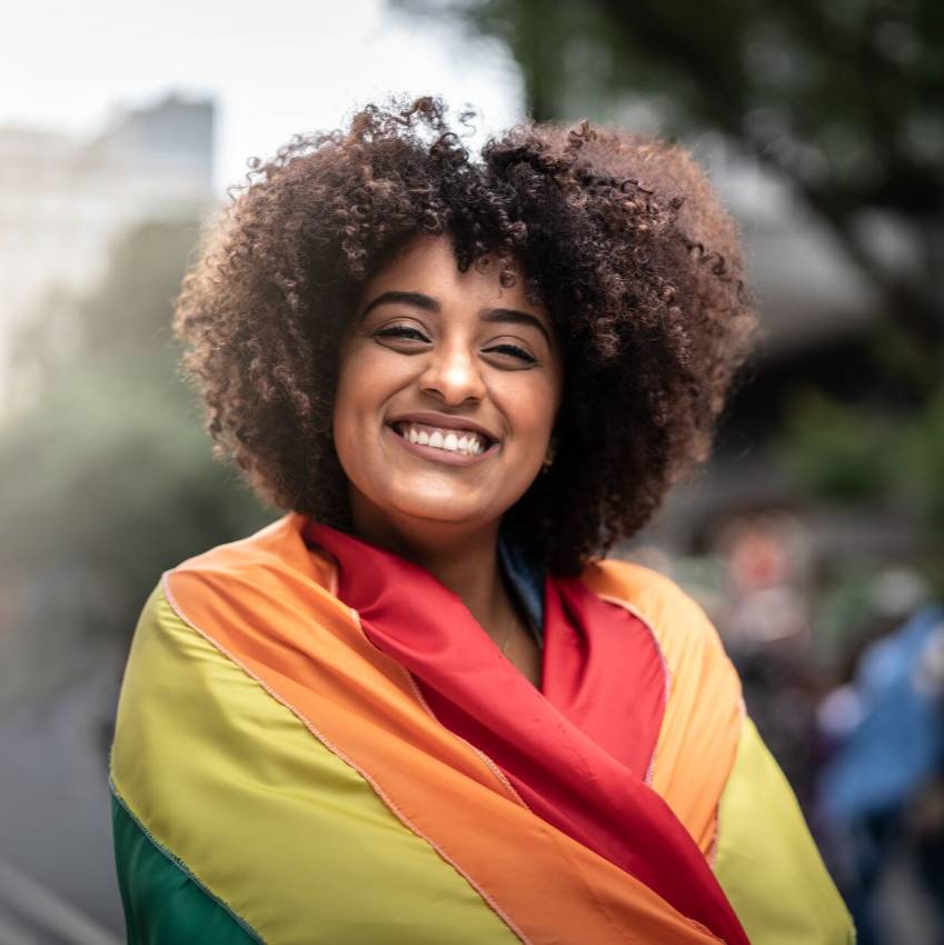 Portrait of a happy woman wearing the rainbow flag