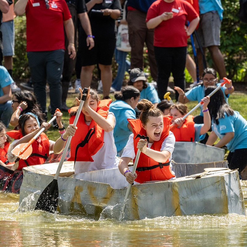 SBU students participating in a boat race