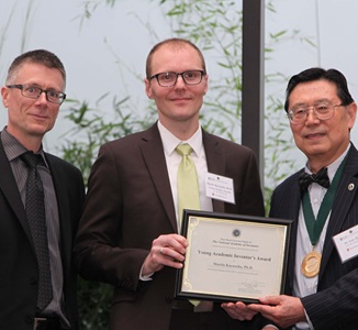 Iwao Ojima and Peter Donnelly with Young Academic Inventor Award recipient