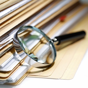 Magnifying glass with document folders