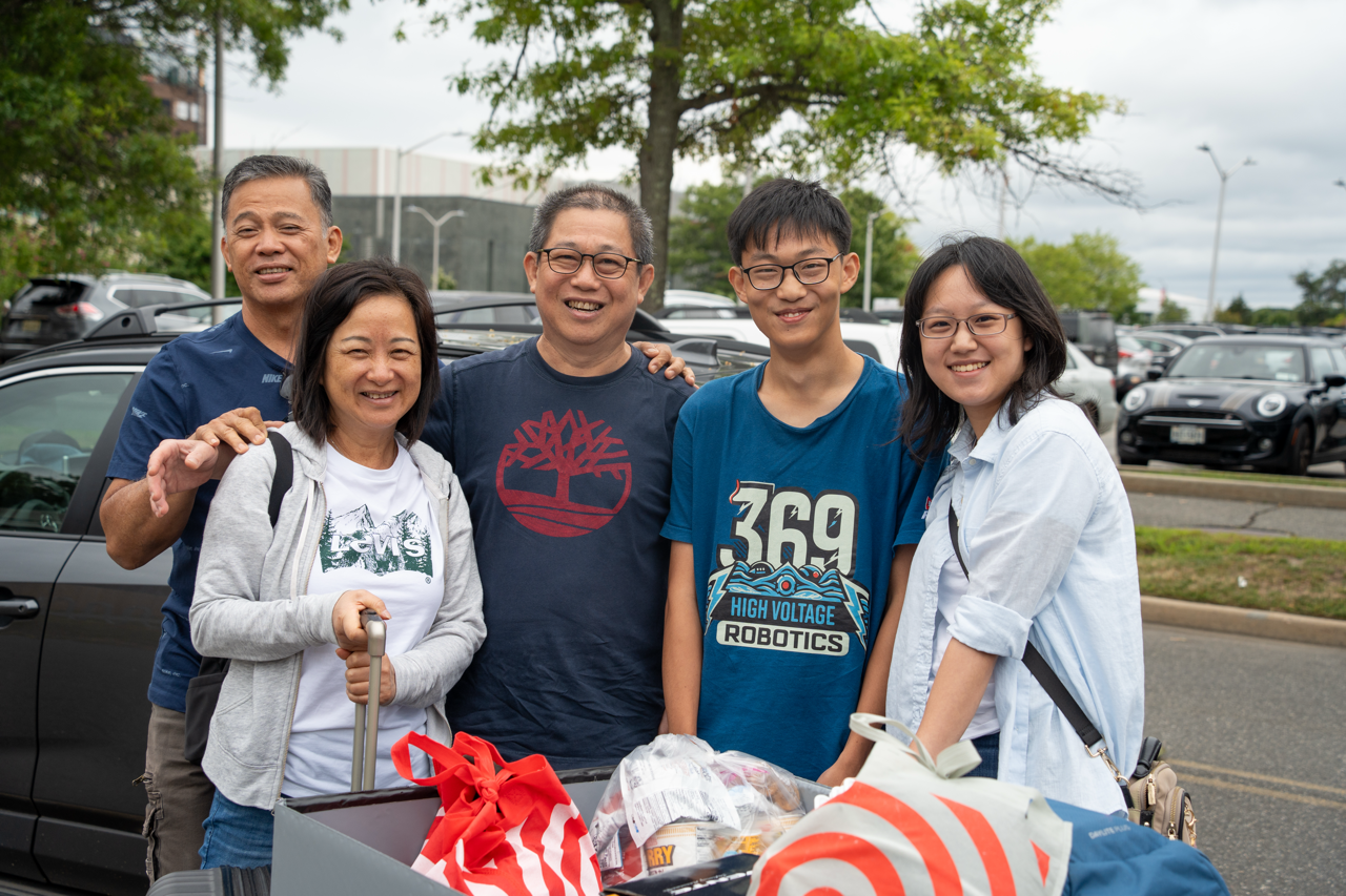 Family of five helping their student move in