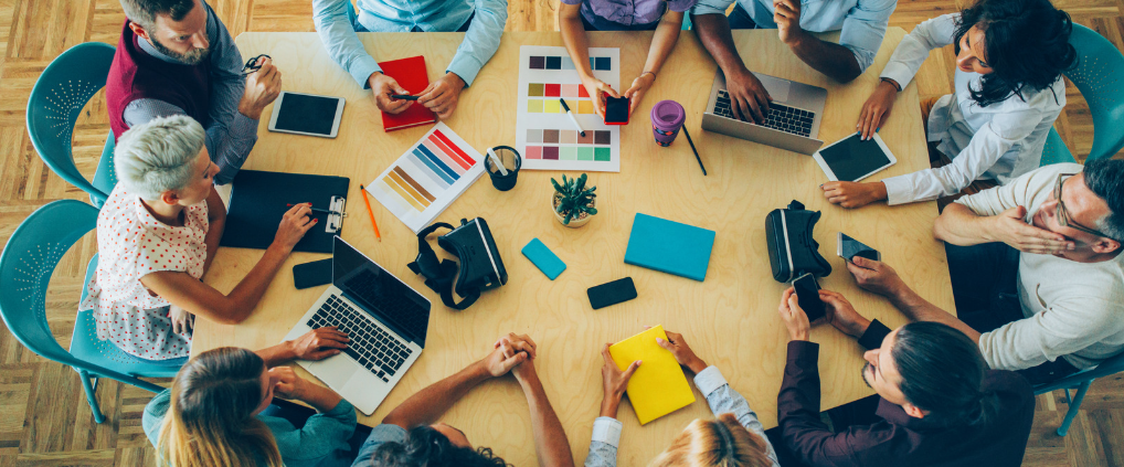 Businesspersons gathered around conference table