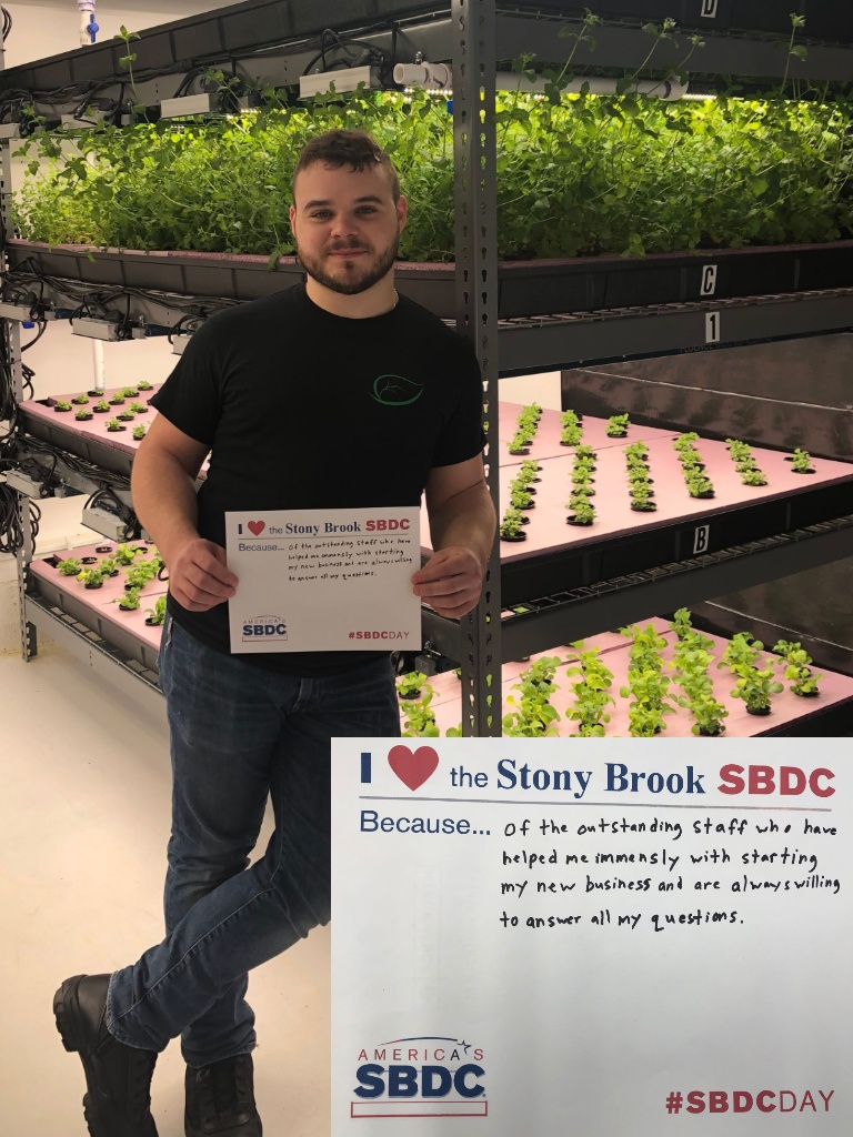 Cory Mahony holding "I love the Stony Brook SBDC" sign