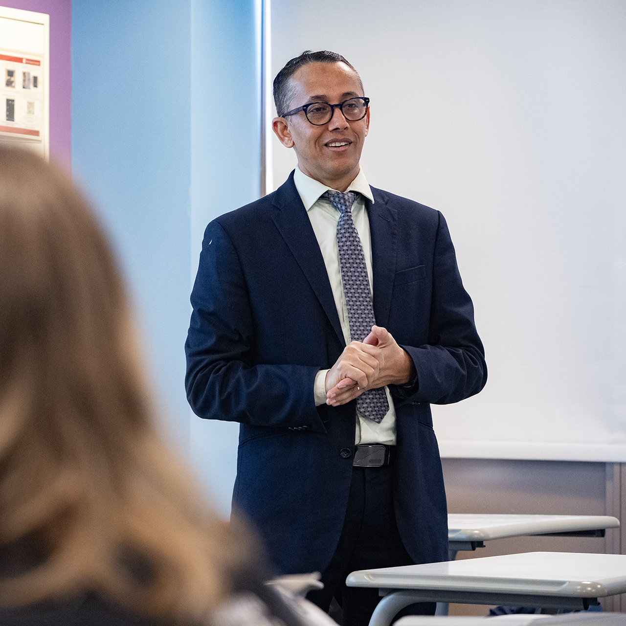 An instructor speaking to their class.