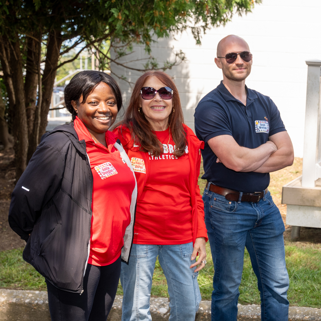 Stony Brook staff posing together outside.