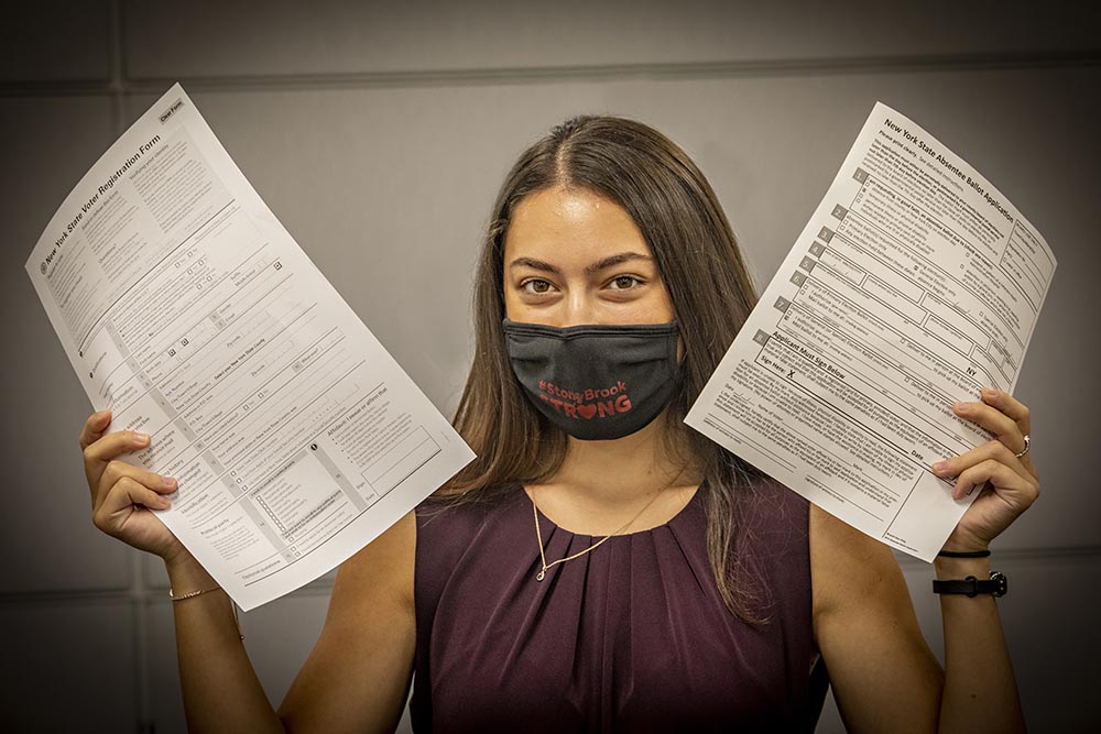 Anne Green holding voter registration forms.