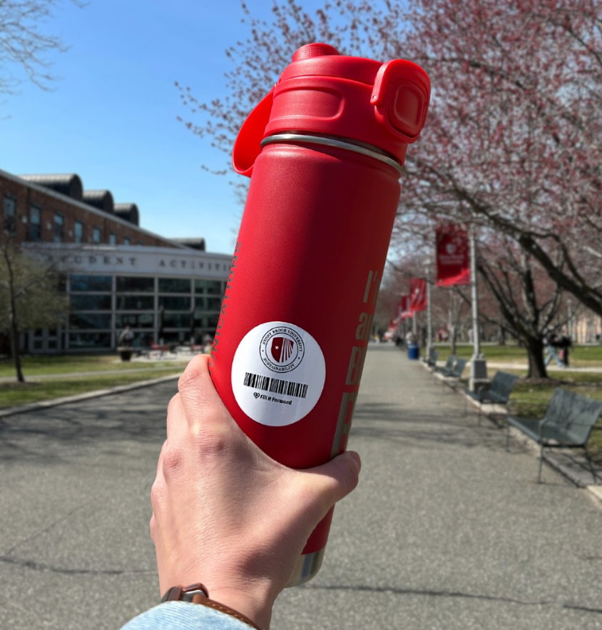 Red water bottle with fill it forward sticker