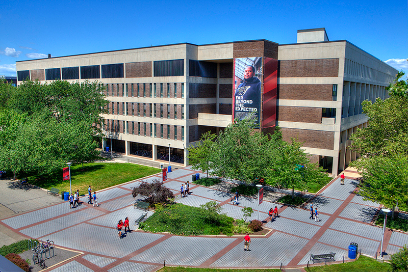 view of Melville Library and students walking 