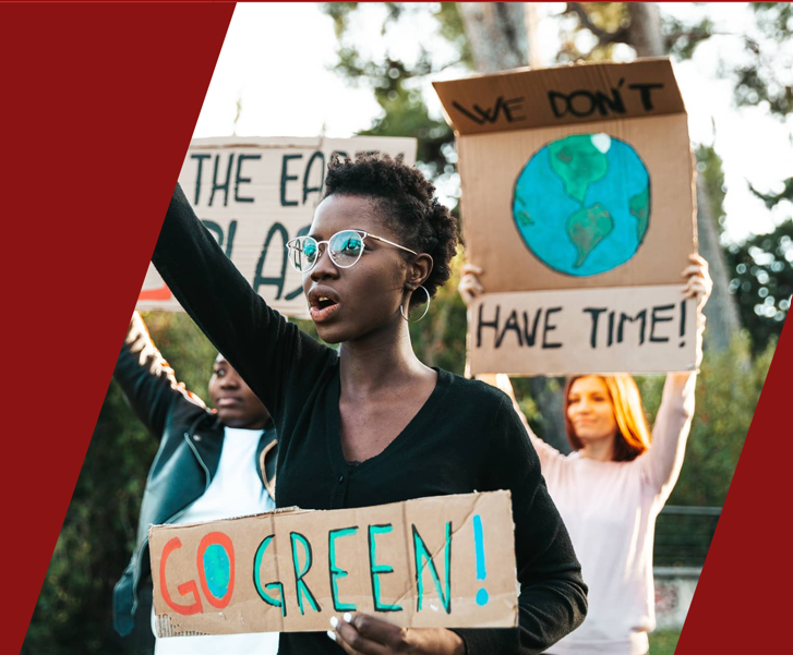 Woman protesting holding a sign that reads "Go Green"