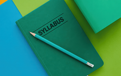 Green notebook with the title Syllabus