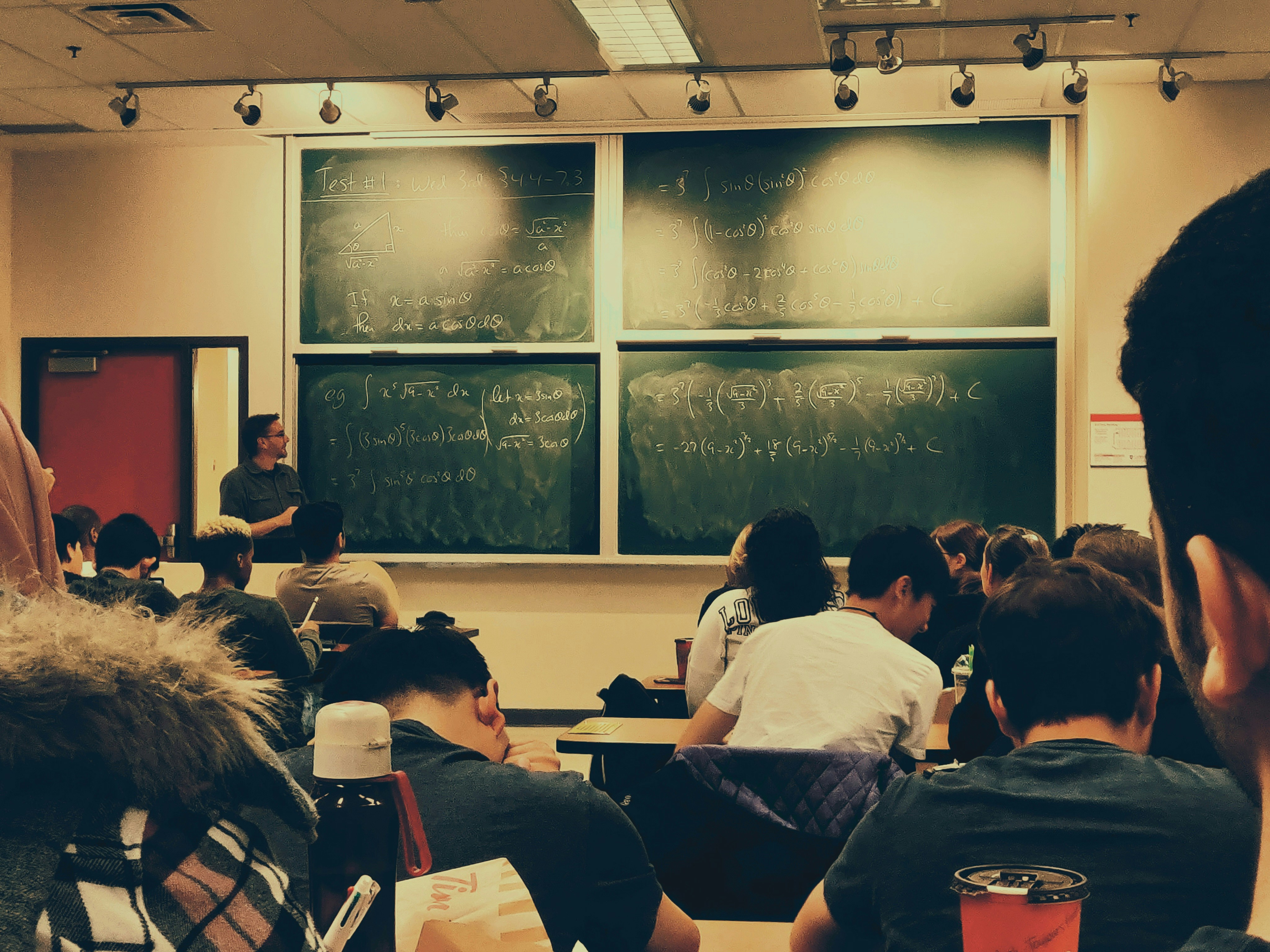 College classroom with students looking at a blackboard