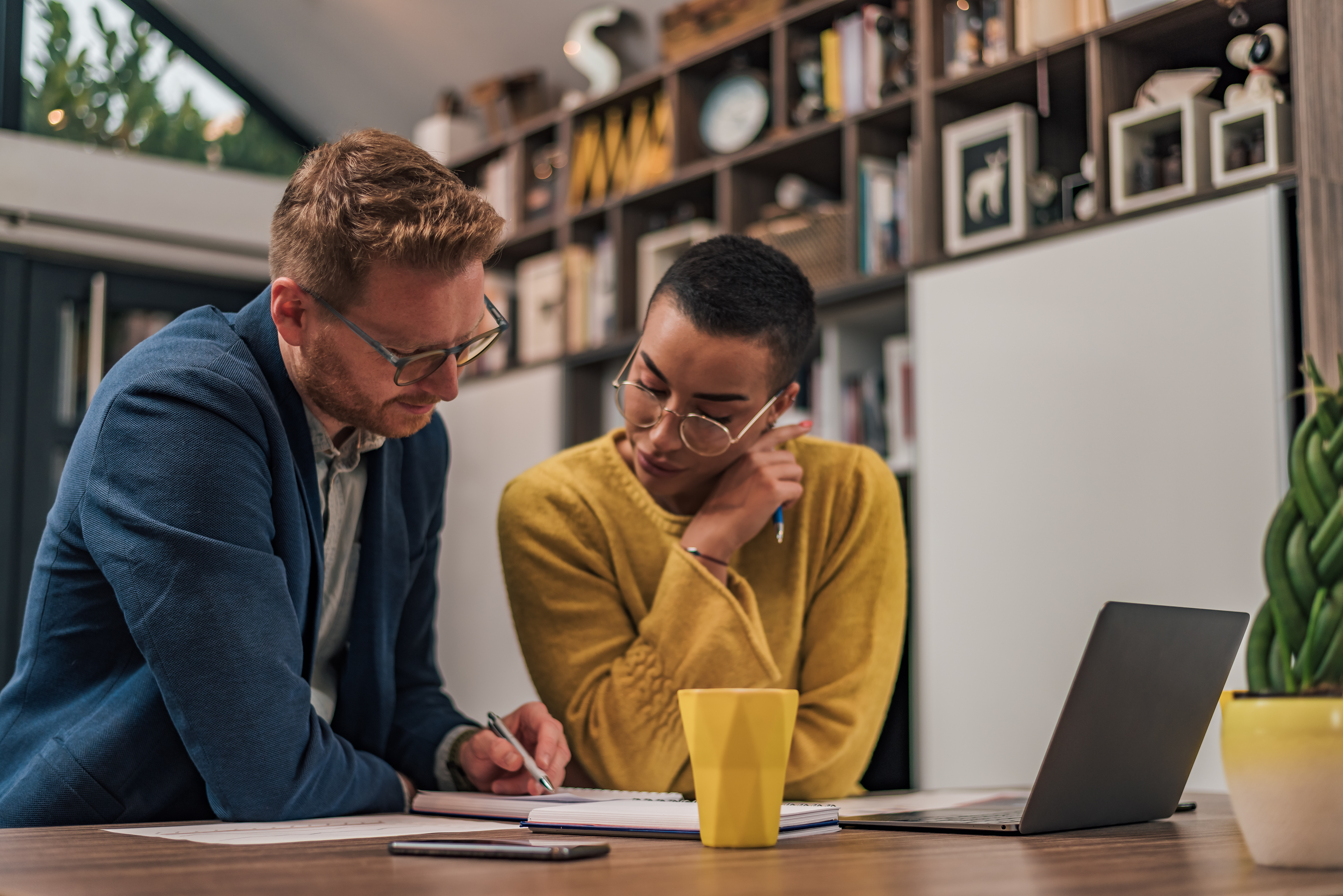 Two people working together at a desk