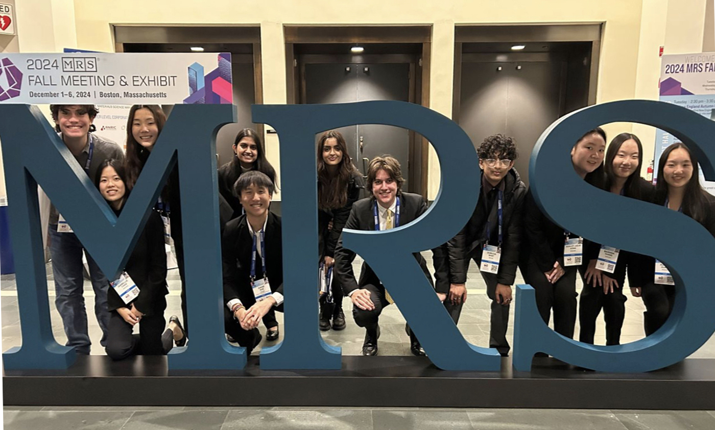 Students posing behind letters MRS
