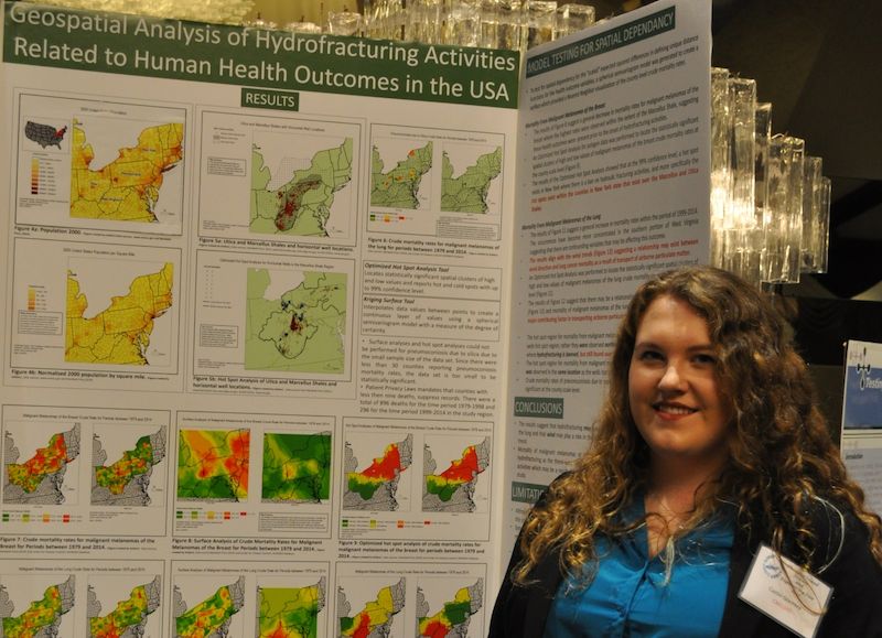 Caitlin Gormley, a Geospatial Sciences student, presents her research poster at a conference.