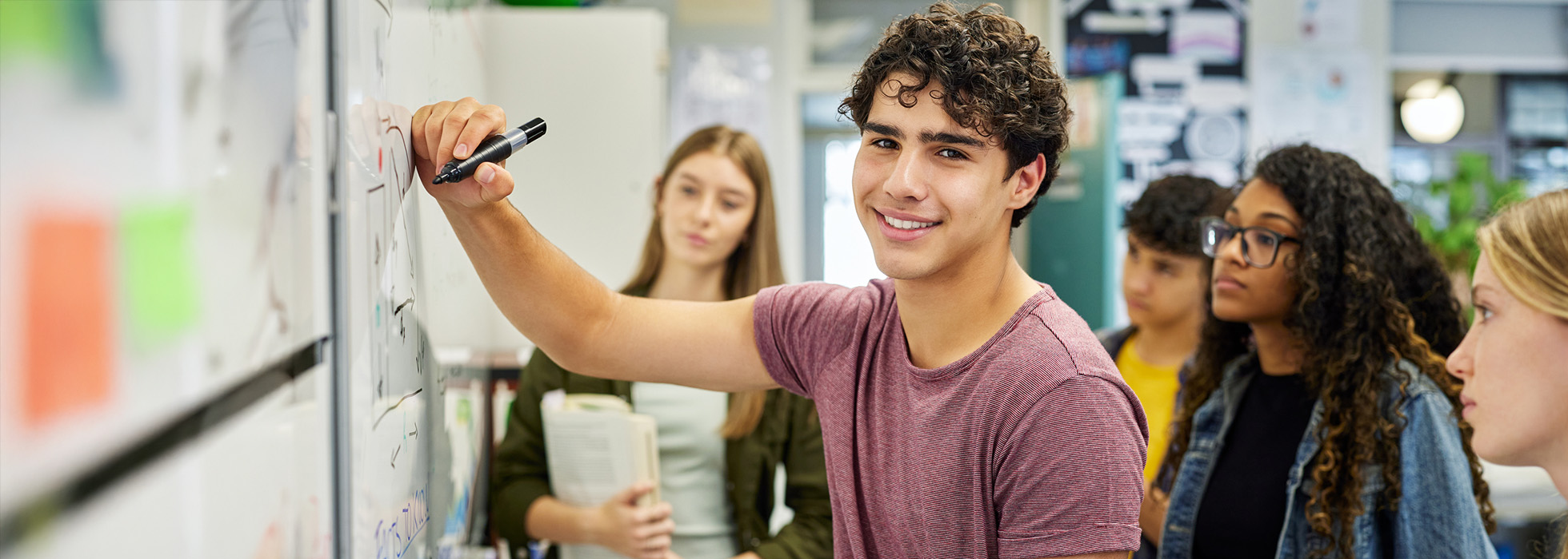 An AMC Prep participant solving a problem on a dry erase board
