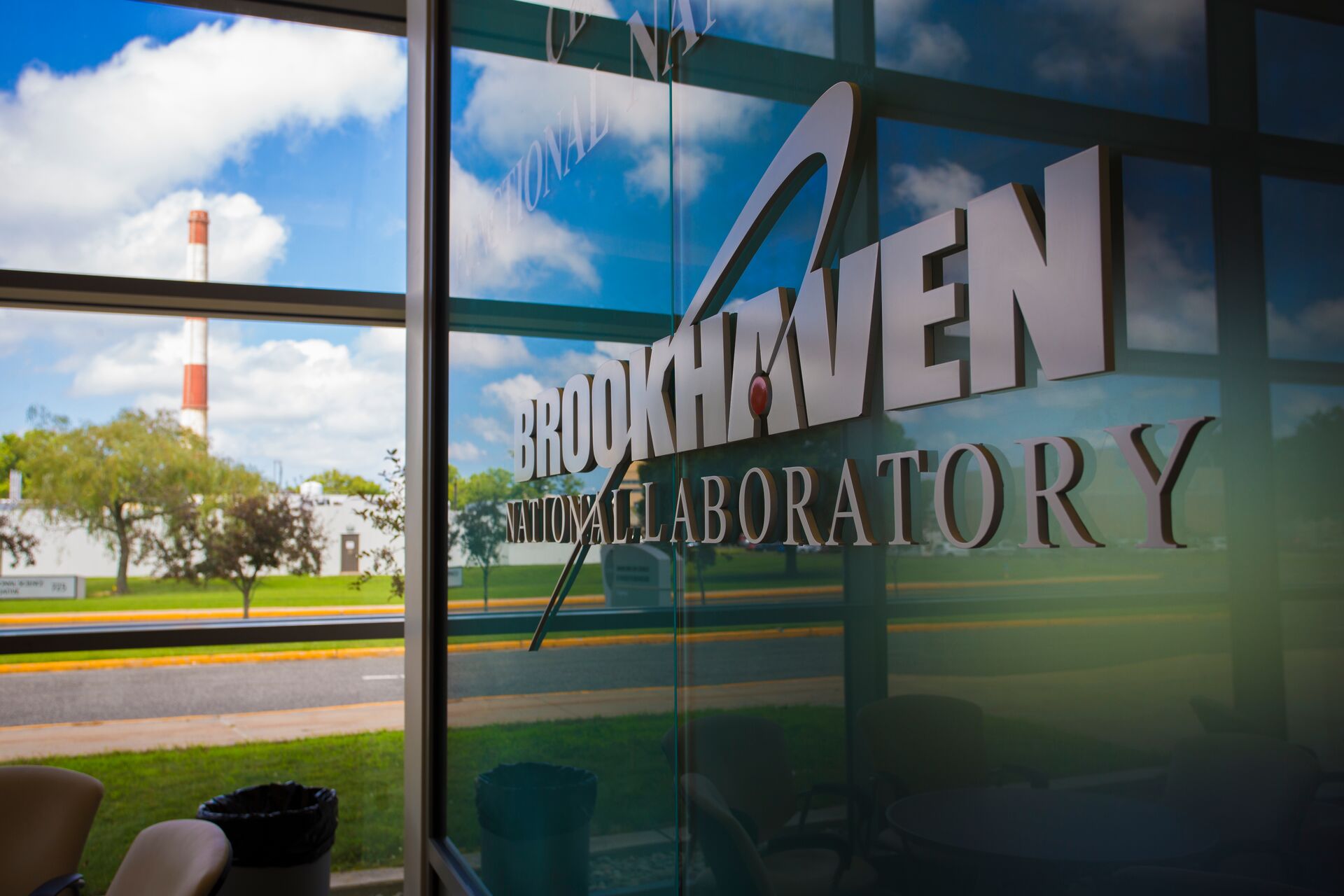The Brookhaven National Laboratory sign with a window beside it on a nice, sunny day