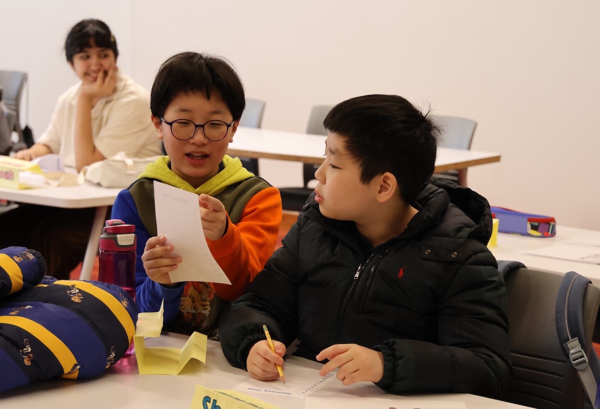 An ICPS participant taking diligent notes during class