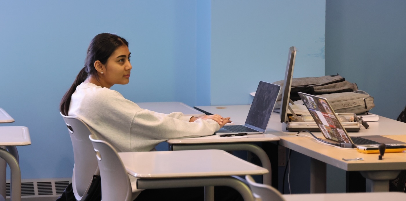 A Research and Tech participant listening to the instructor while on her laptop
