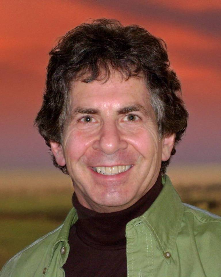 Rob Gerver smiling in front of the setting sun
