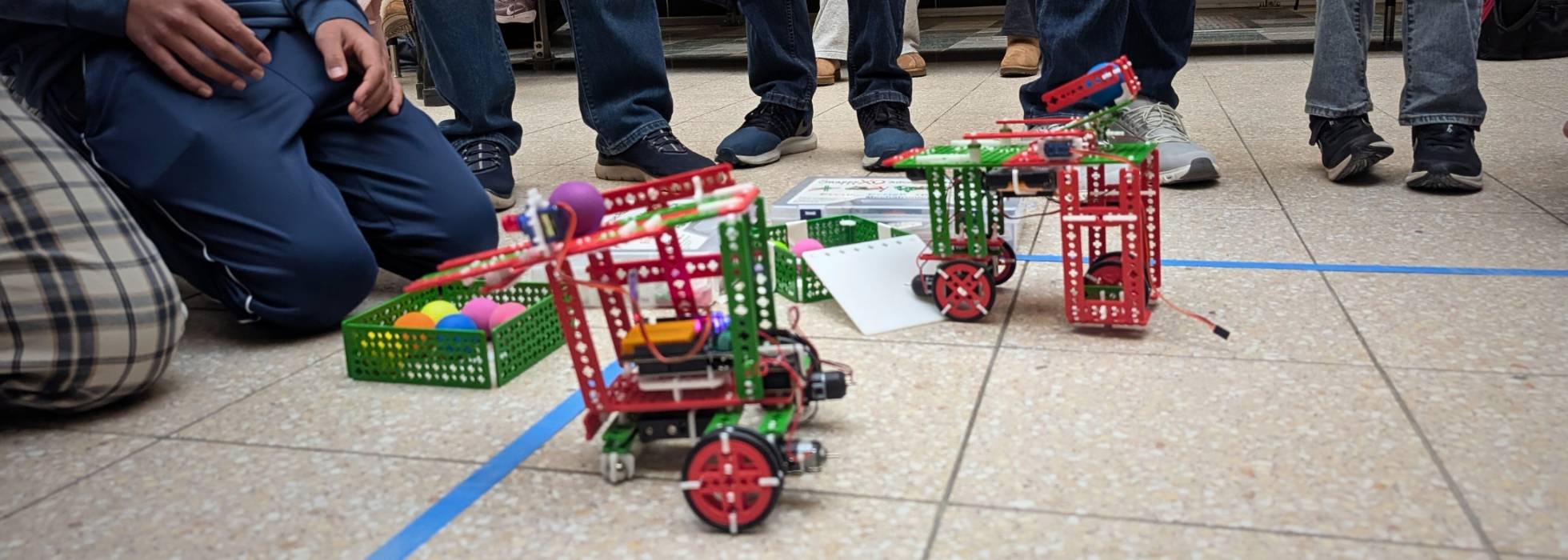 Two robots competing to corral colored table tennis balls