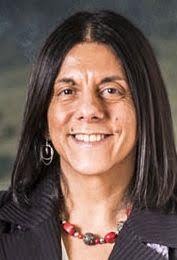 Antonella Sorace headshot, person has medium length black hair and in a blazer.