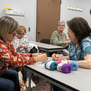 Group of people learning to crochet