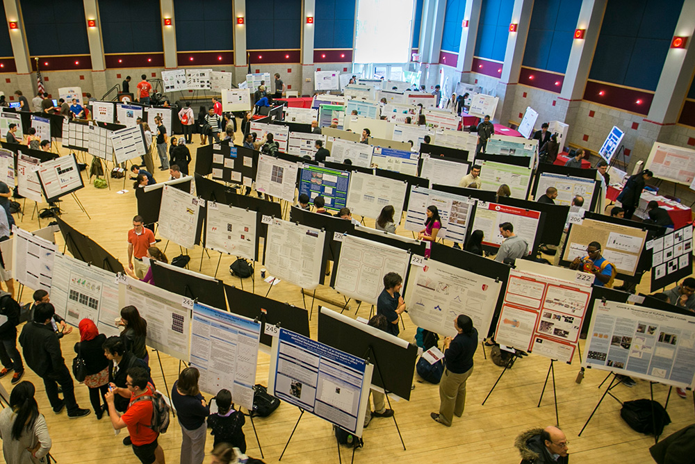Overhead view of students presenting research posters at a university poster session