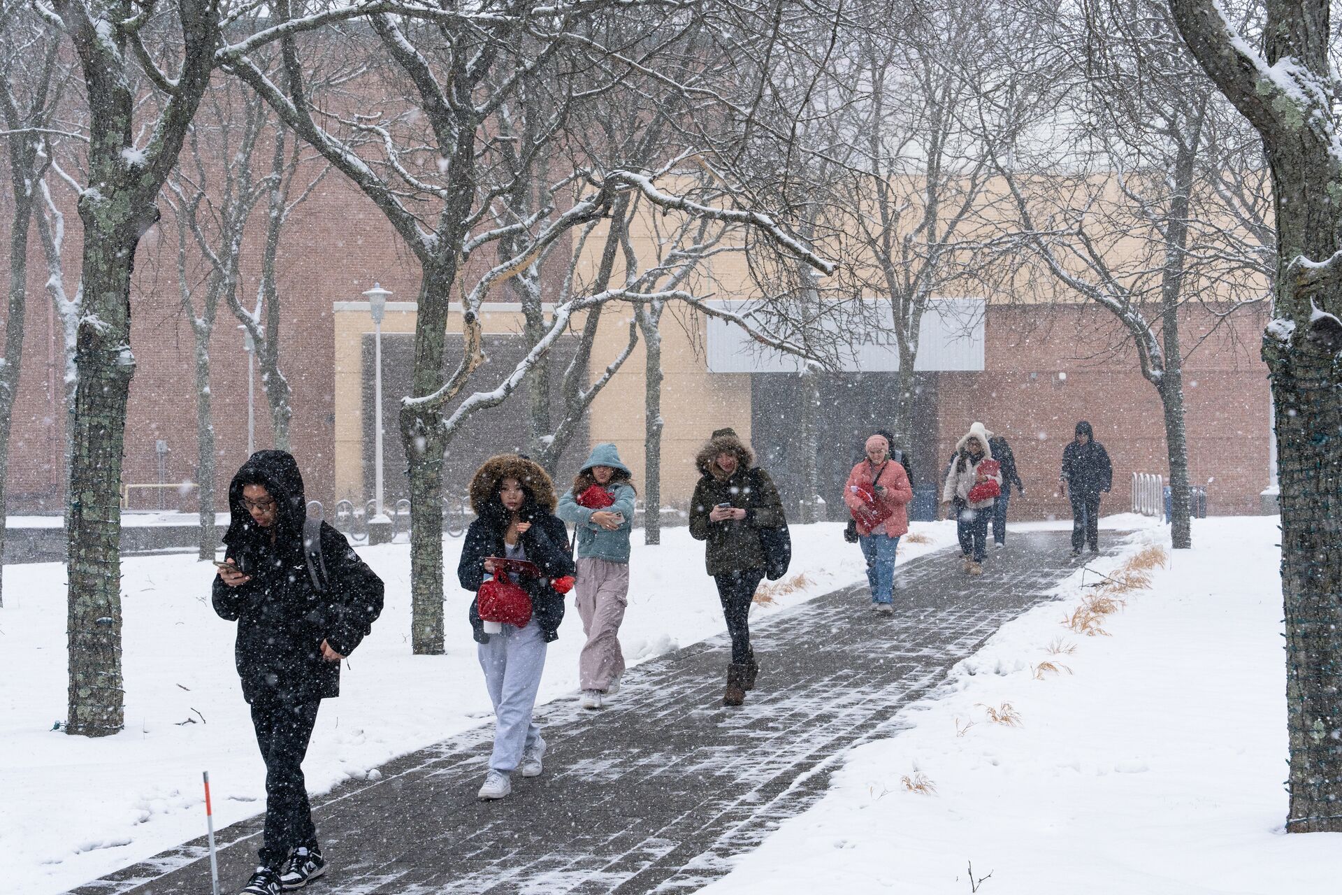 students walking on campus during snowy day