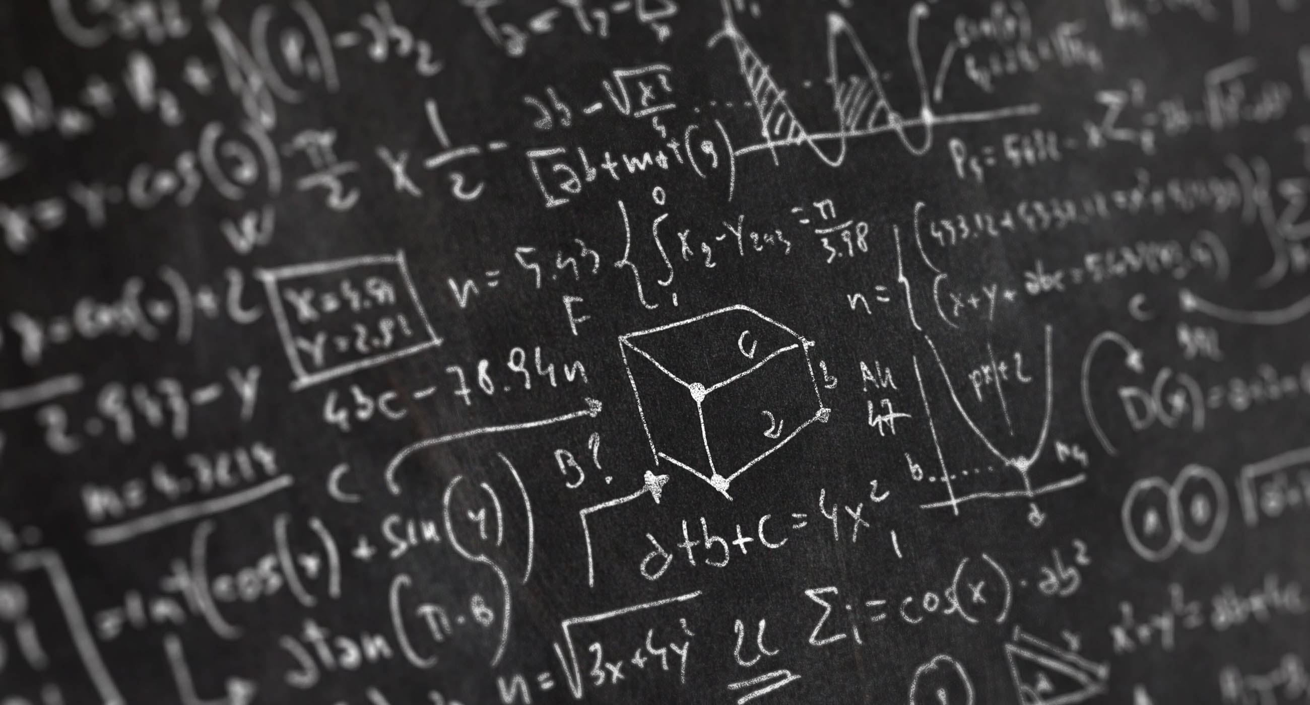 Chalkboard filled with math equations.