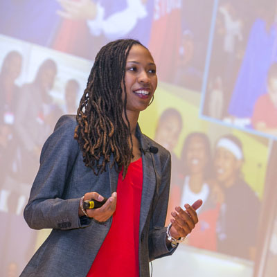 Woman giving a presentation infront of a screen