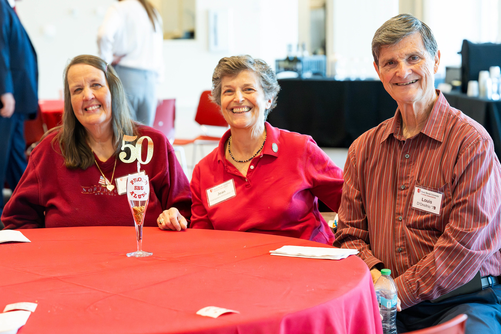 Three alumni smiling