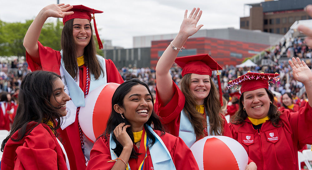 students celebrating graduating