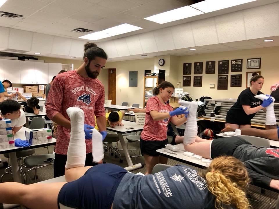 Alumni in medical setting practicing on student