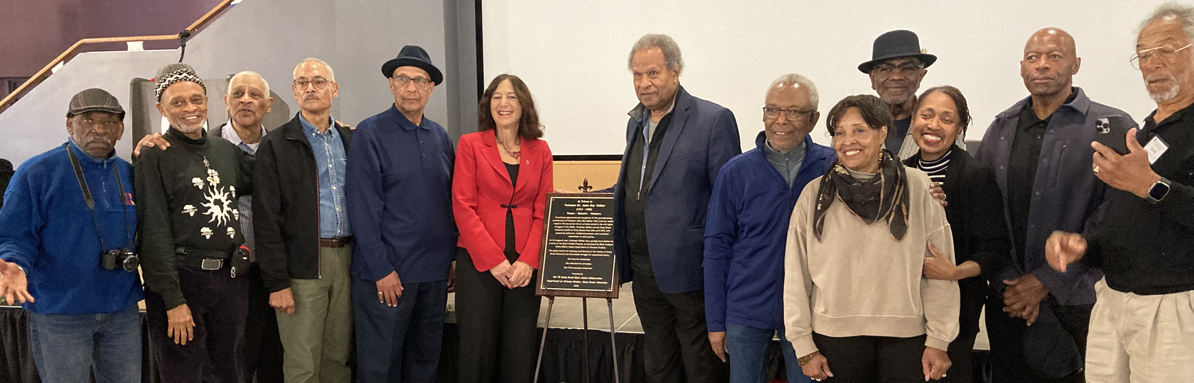 Alumni from 1975-1979 present plaque to President Goldsmith honoring Black Studies founder Dr. Annie Mae Walker