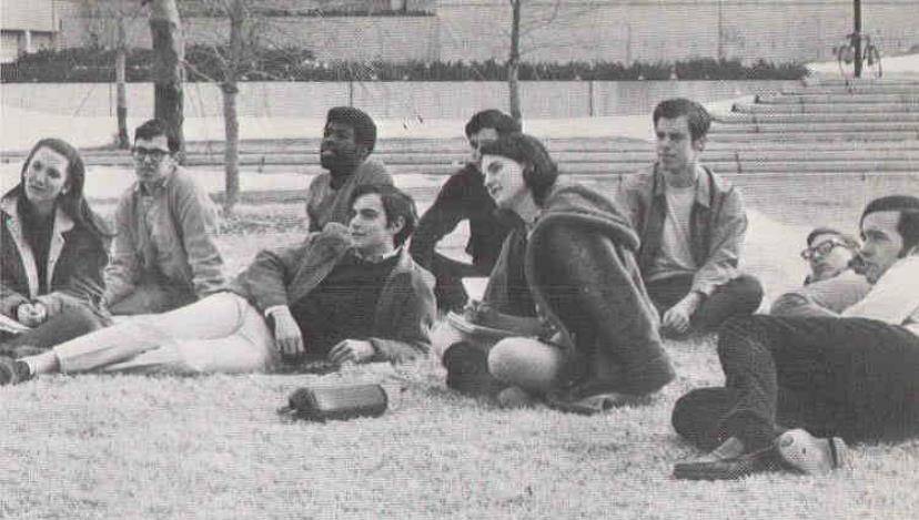 Reunion featured event Alumni laying on campus lawn