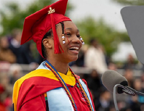 Student laughing at podium during commencement