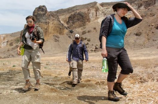 Turkana Basin Institute study abroad students walking across a dry savanna landscape