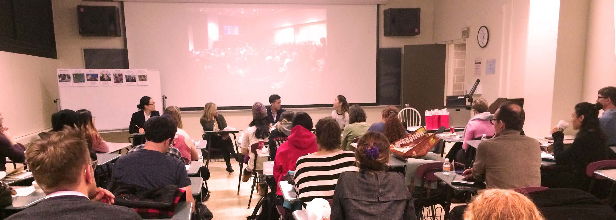 One of the lecture halls. Faculty and students are discussing art history.