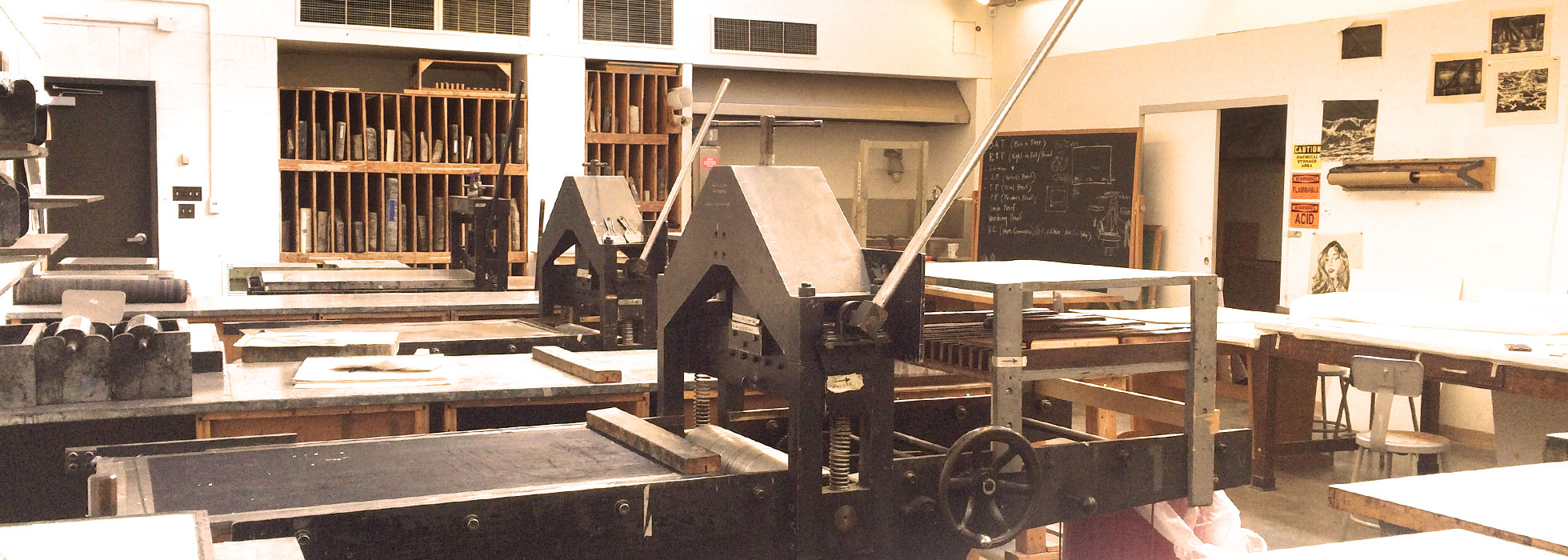 Lithography presses are neatly lined up in the bright print room.