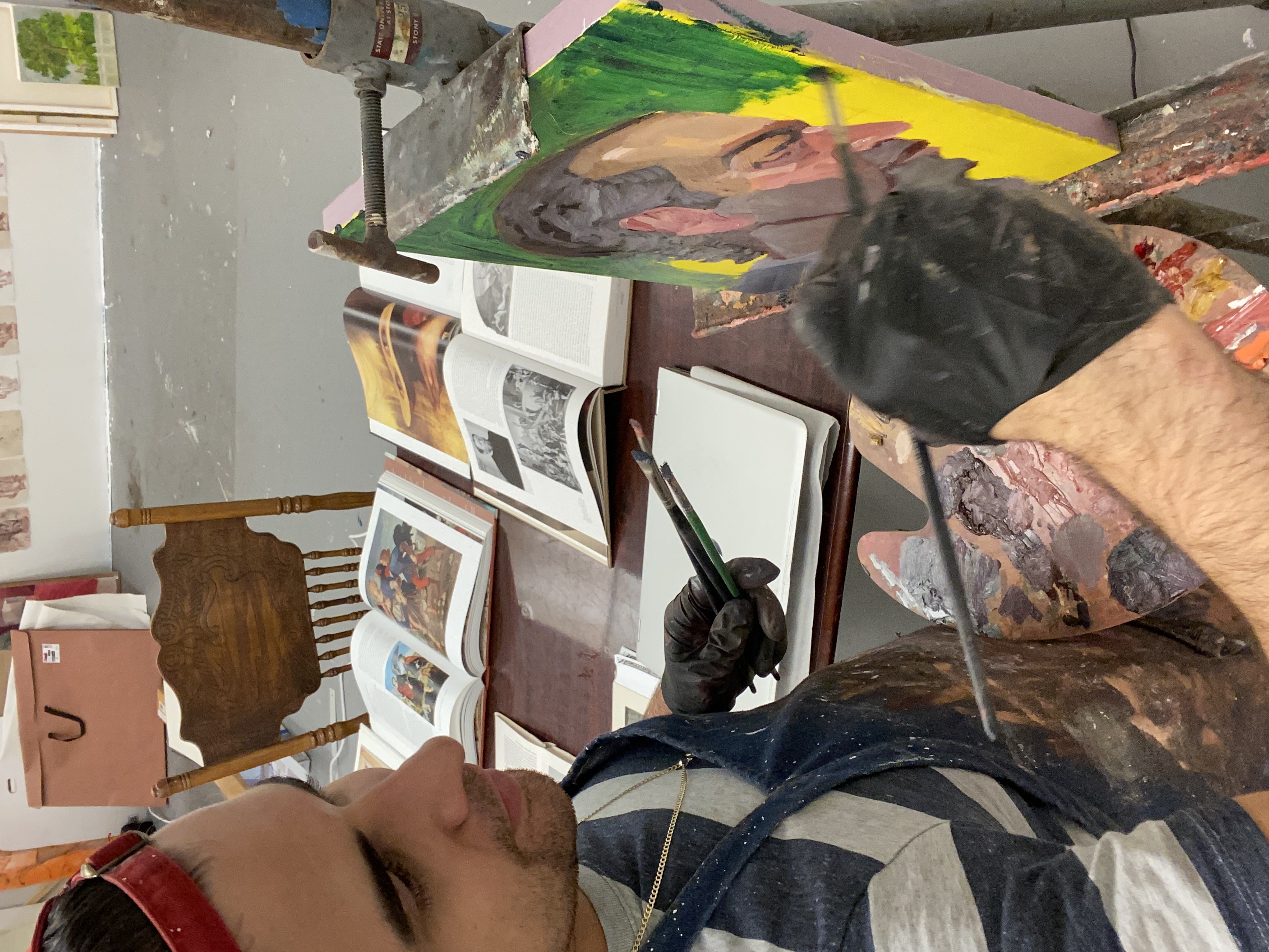 closeup photo of Daniel Donato painting a canvas
