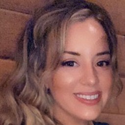 Caucasian woman with bleached wavy hair, photo cropped close to face