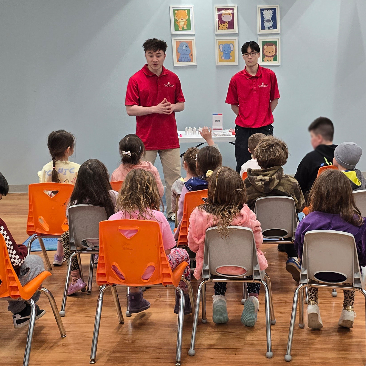 two students presenting infront of youth