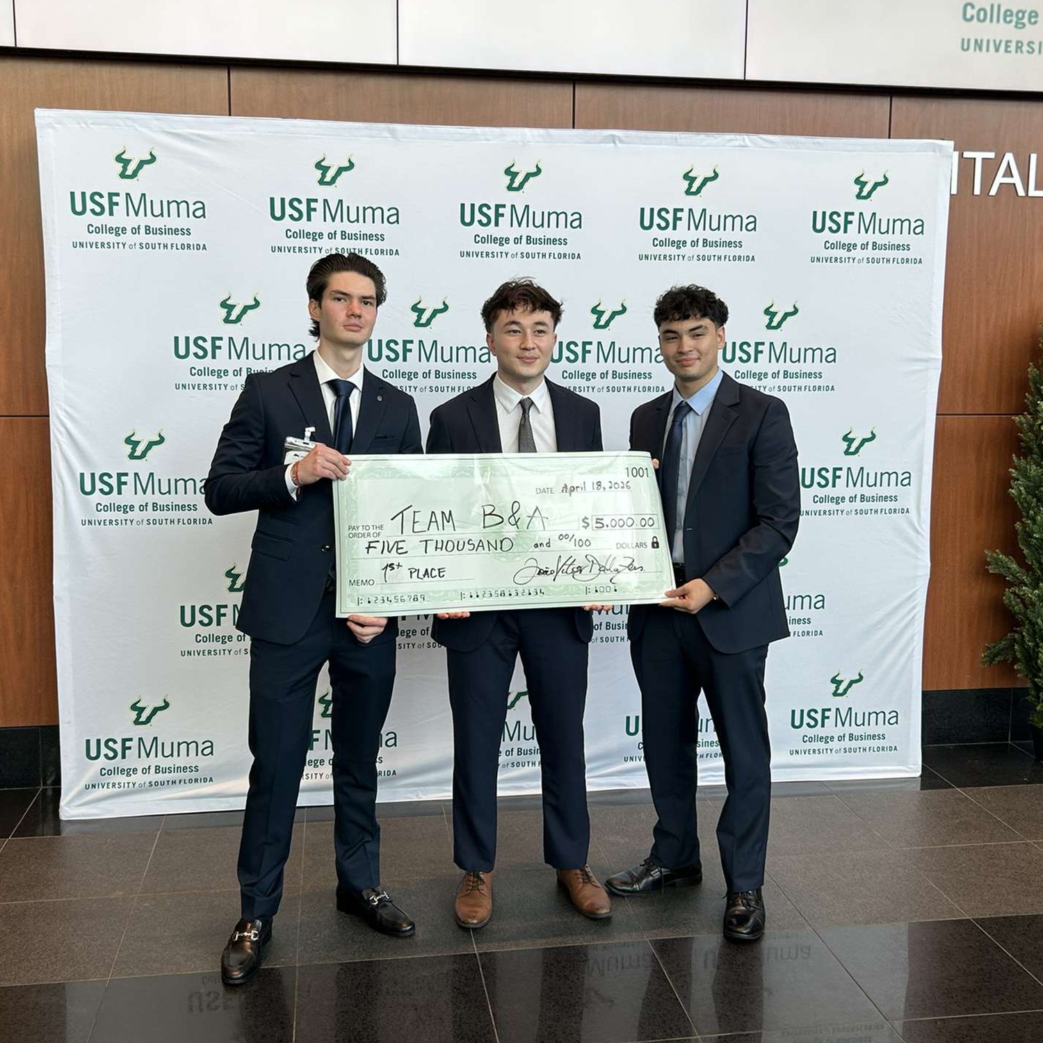 students holding first place prize check at the USF pitch competition