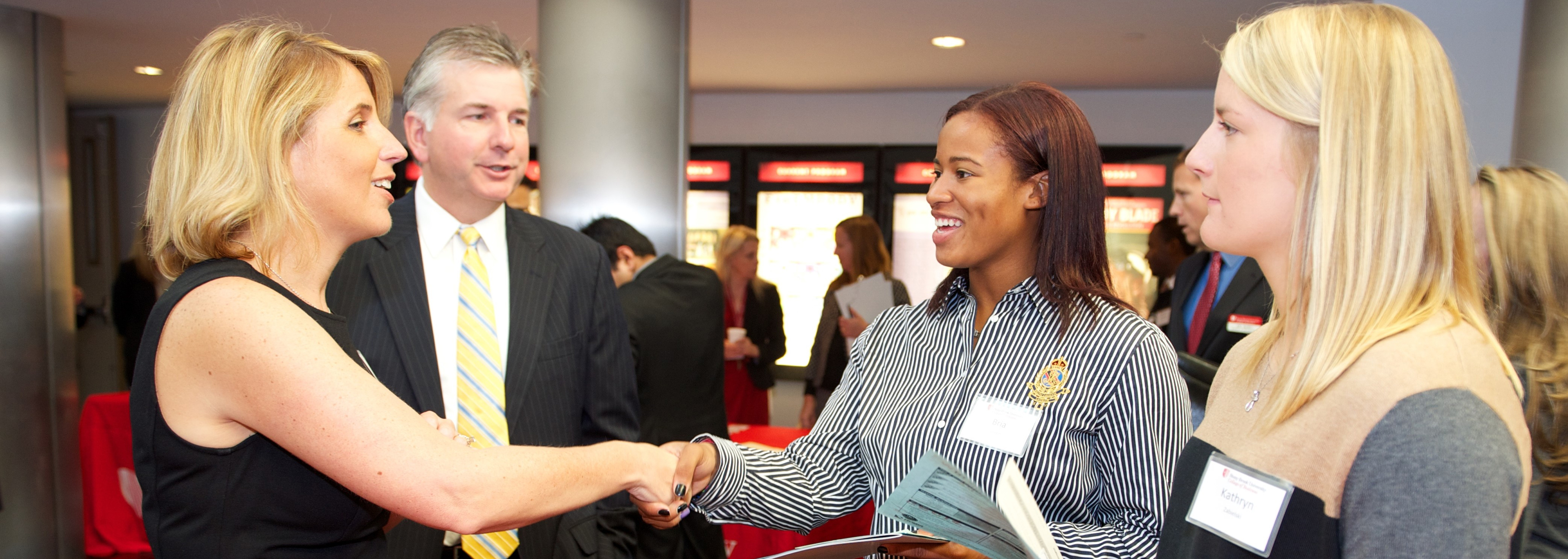 Four people networking at an accounting event
