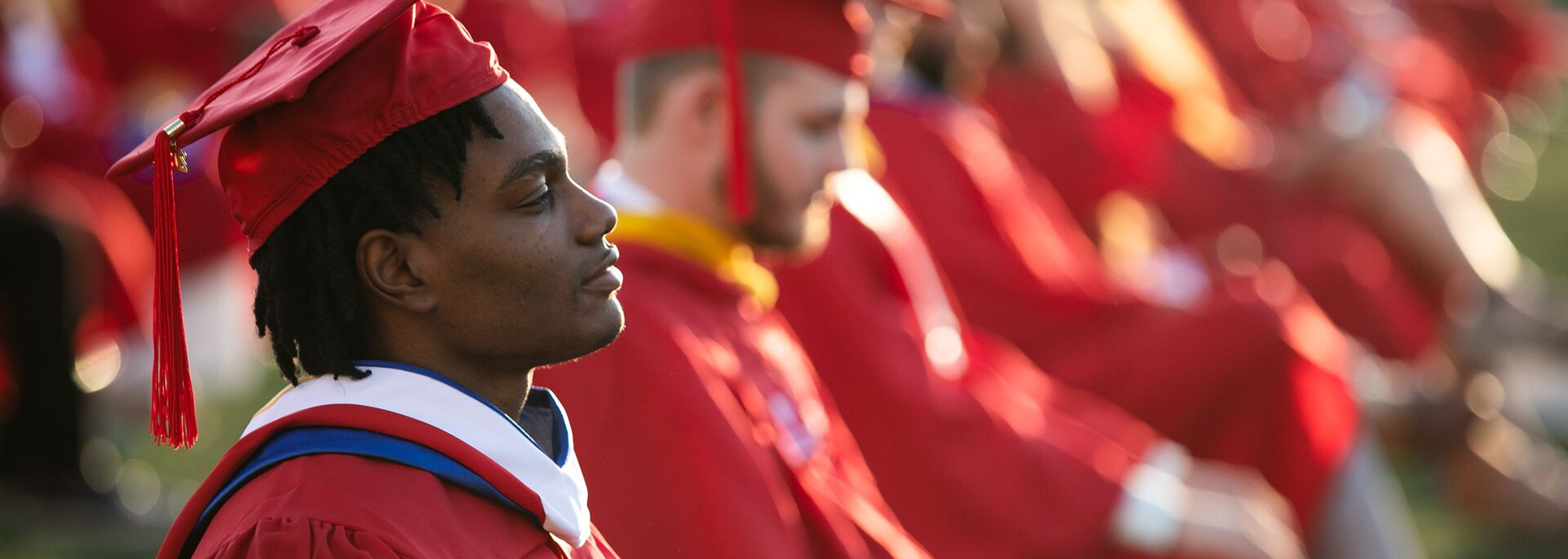 student with graduation regalia on attending convocation