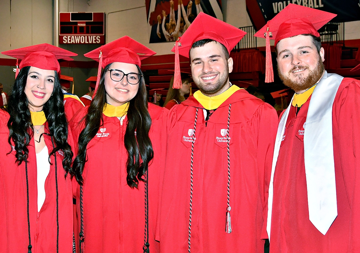 four student in convocation regalia