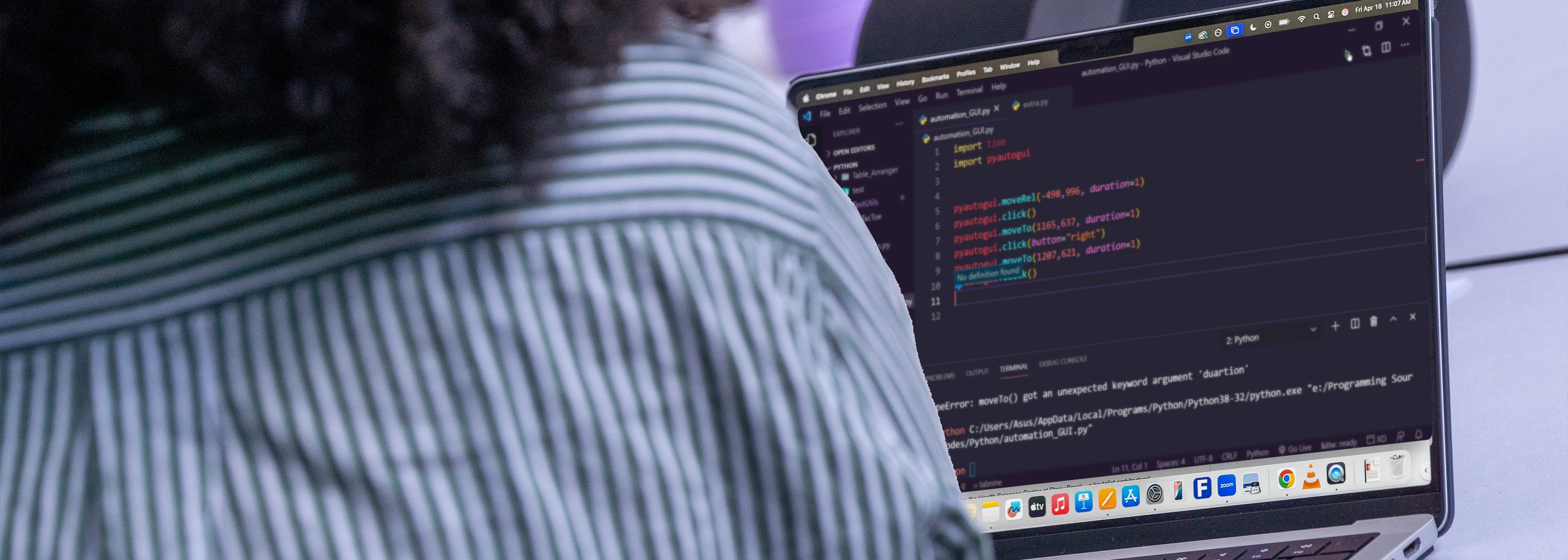 person on computer with code terminal open